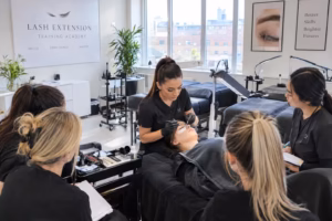 how to start a beauty training academy UK - trainer demonstrating lash technique to students