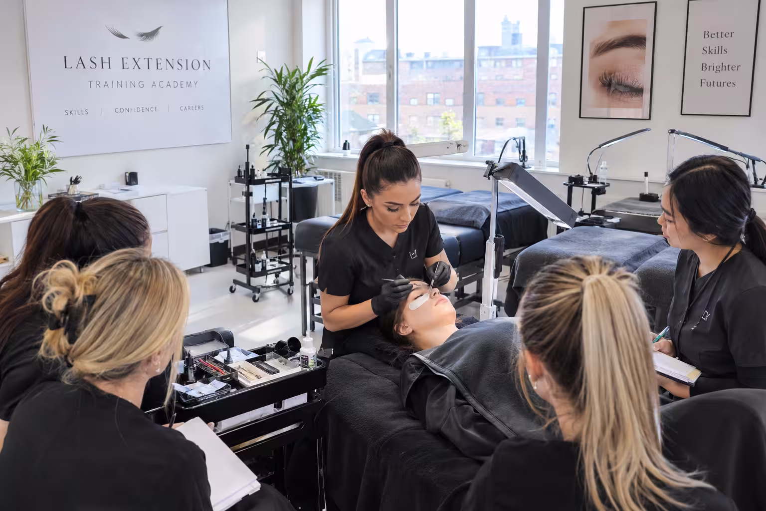 how to start a beauty training academy UK - trainer demonstrating lash technique to students